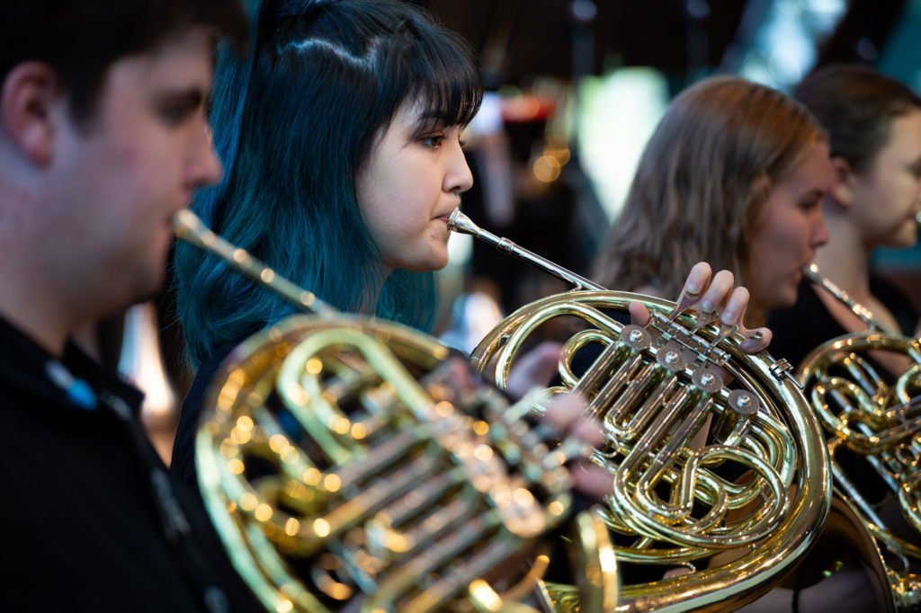 The French Horn section of an AYO orchestra perform during a concert.