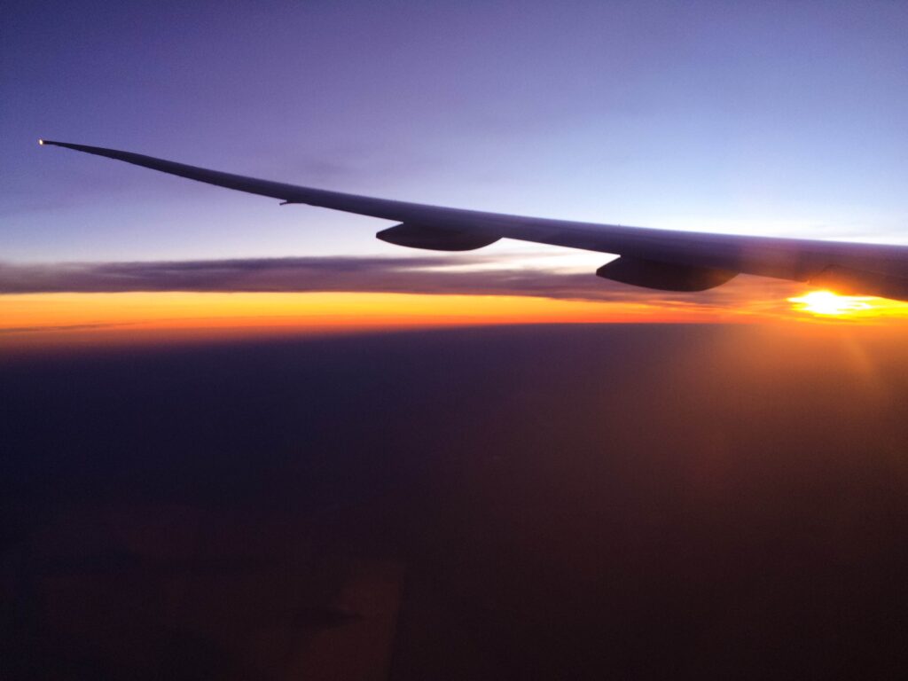 Photo of a sunset taken from an airplane window.