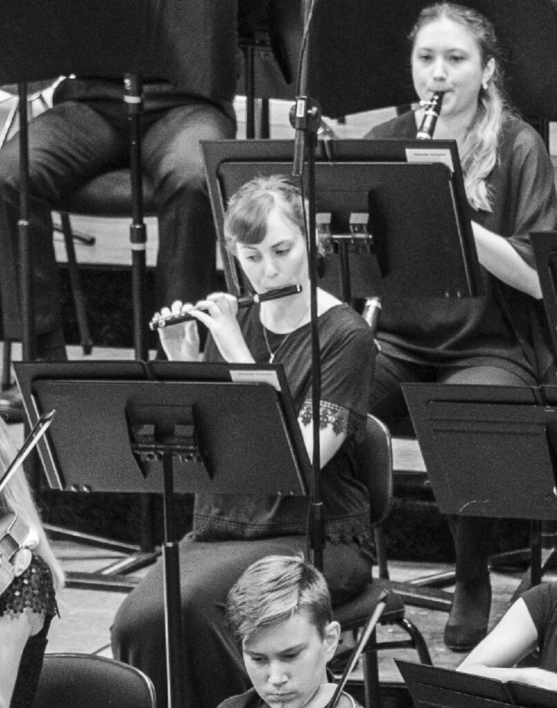 AYO flautist Laura Cliff plays the piccolo during an orchestra performance. 