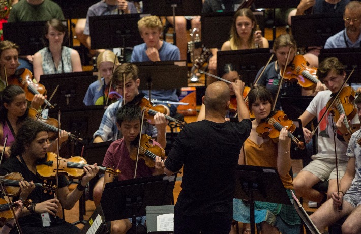 Conductor Dietrich Paredes leads a rehearsal at AYO National Music Camp 2017