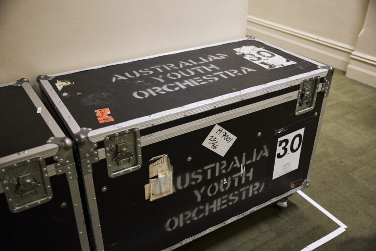 A black roadcase with Australian Youth Orchestra printed on the side