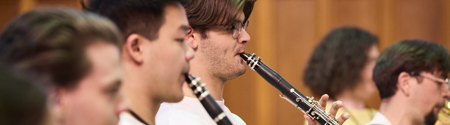 View of two clarinettists and a French Horn player rehearsing during AYO National Camp 2023.