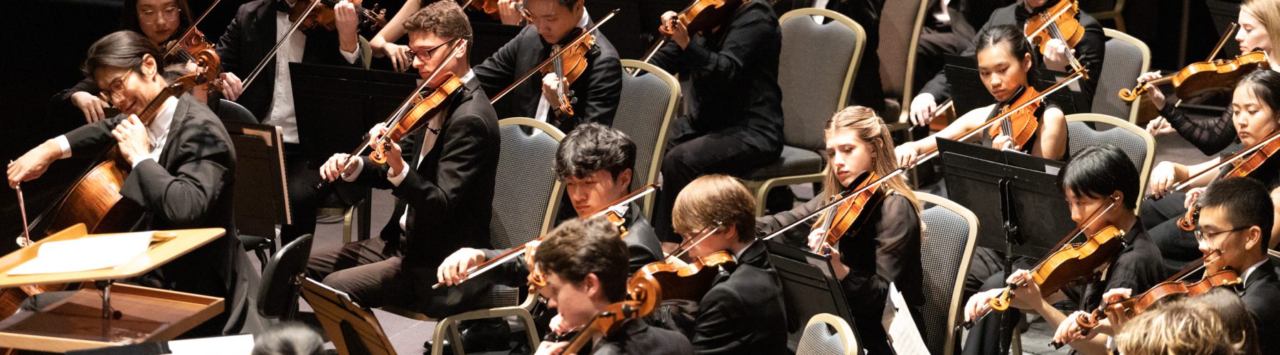 The Australian Youth Orchestra perform on the Melbourne Town Hall stage. They are wearing concert blacks.