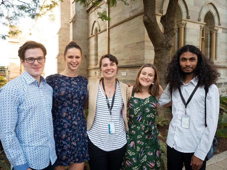 5 participants of AYO National Music Camp 2019 pose outside for a photo. They are all smiling.