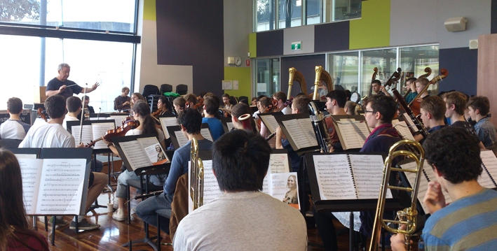 The orchestra rehearses with Max McBride during AYO Young Symphonists 2014.