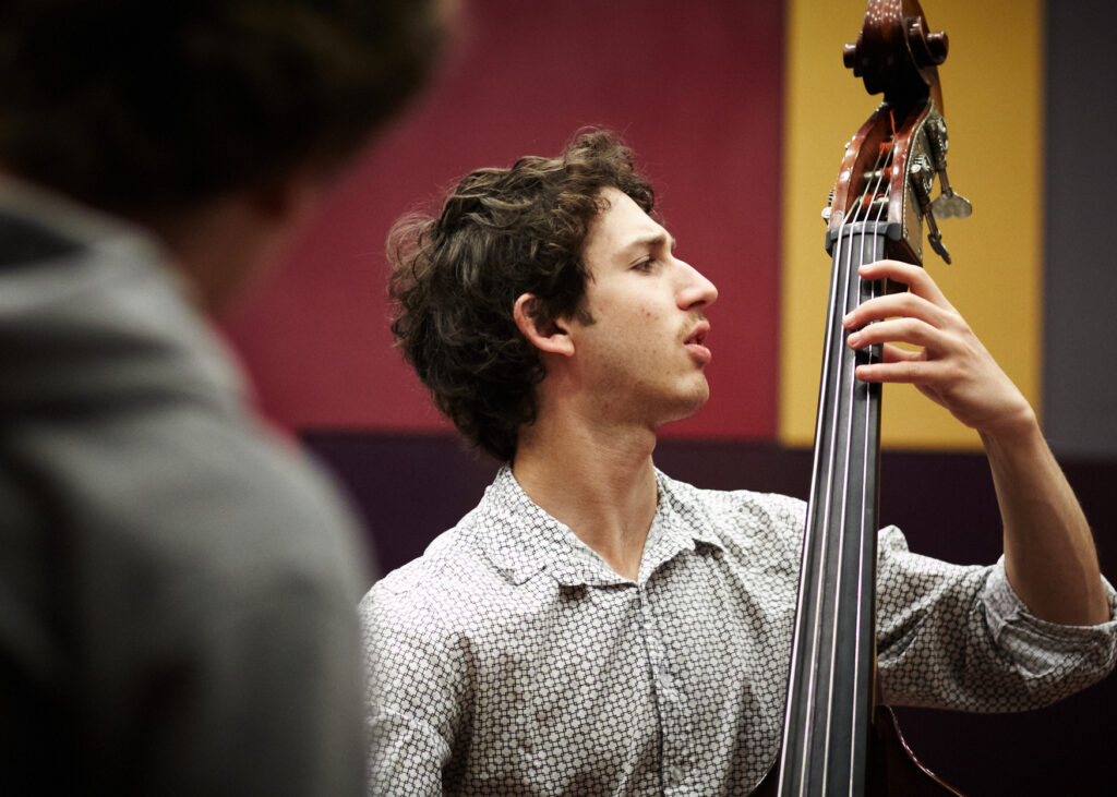 A double-bassist plays his instrument during a rehearsal.