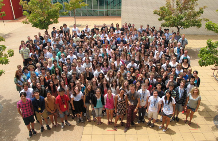 A crowd of over a hundred participants and staff smile at the camera for the AYO National Music Camp 2012 photo. 