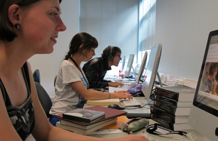 Three young writers pictured working on their computers