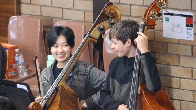 two young doublebassists with their instruments